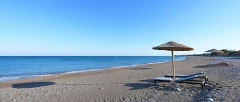 On the beach, sun-loungers