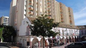 A multi-story hotel with balconies, a central courtyard, and a traditional facade. - Tamarindos (Benalmádena)