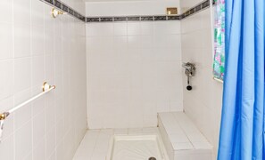 A shower area with white tiles, a showerhead, and a curtain. - Homerez - House in Arles sur Tech (Arles sur Tech)