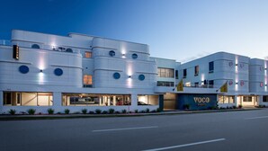 A modern building with a flat facade, large windows, and a prominent 'VOCO' sign. - voco St. Augustine Historic Area by IHG (St. Augustine)