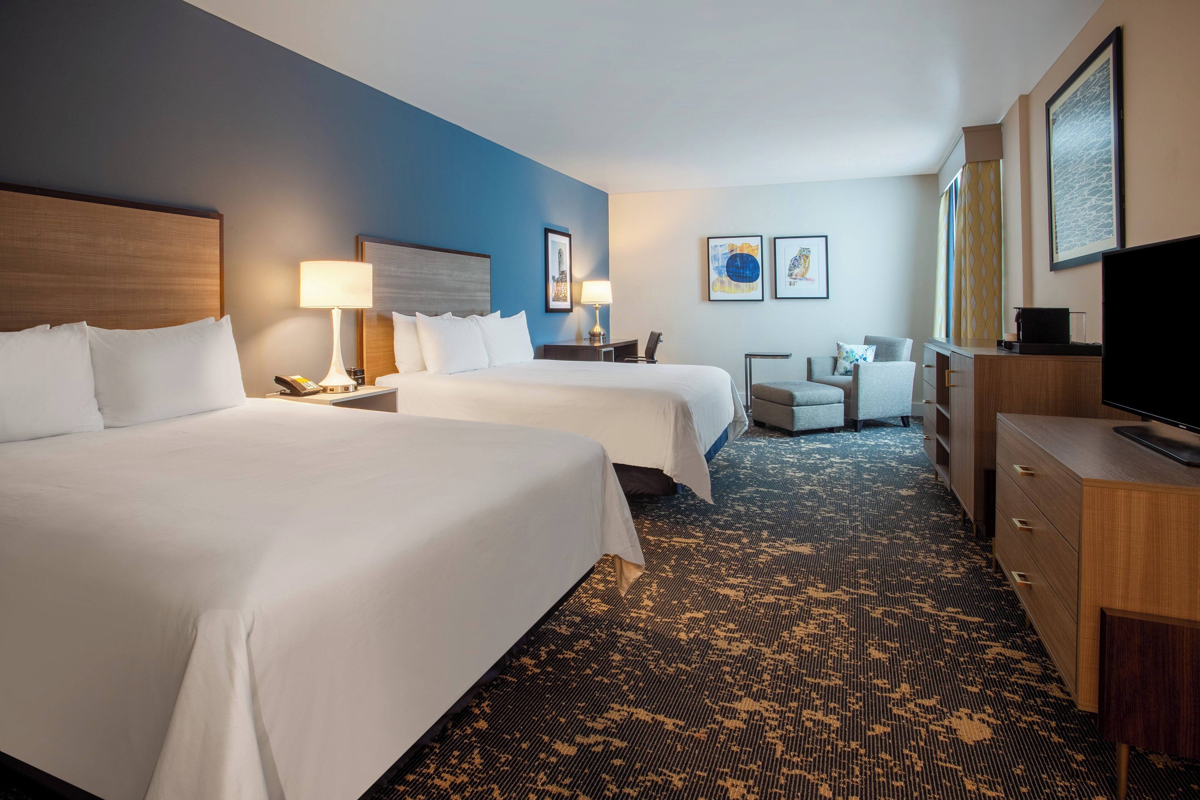 Premium bedding, desk, laptop workspace, blackout drapes