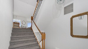 A staircase with wooden railings and carpeted steps leading to a landing. - Bay Front with Private Pool - North Island - 3BR Dock Holiday (Fort Myers Beach)