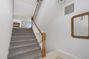 A staircase with wooden railings and carpeted steps leading to a landing. - Bay Front with Private Pool - North Island - 3BR Dock Holiday (Fort Myers Beach)