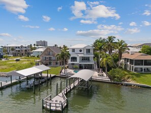 A waterfront property with multiple buildings, a dock, and a pool area. - Bay Front with Private Pool - North Island - 3BR Dock Holiday (Fort Myers Beach)