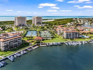 A coastal resort with multiple high-rise buildings, a marina, and a tennis court. - Beachfront 2BR/2BA South Seas condo with pool, Wi-Fi, and heated pool. (Marco Island)
