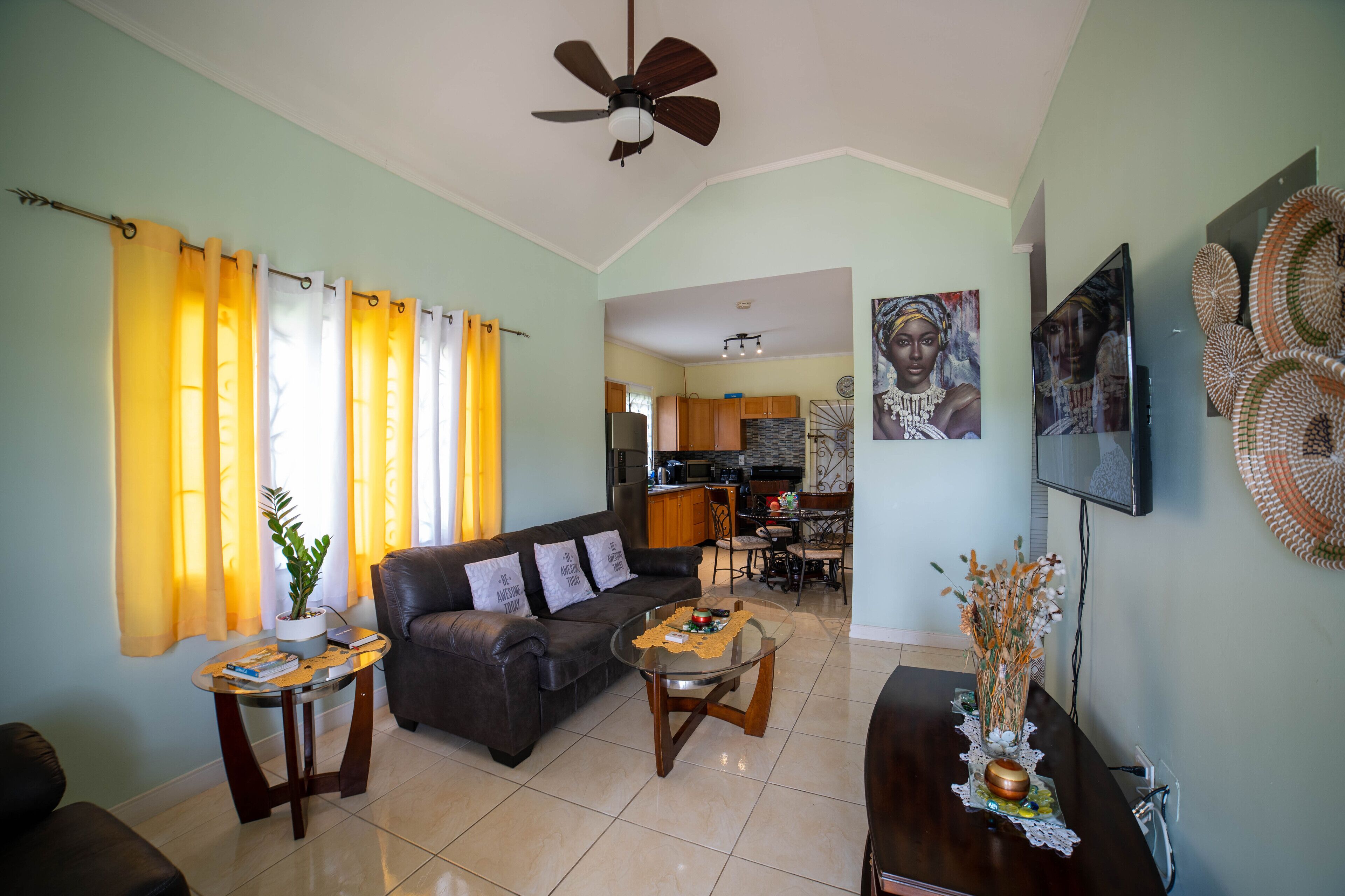 A living room with a sofa, coffee table, and a dining area with chairs.