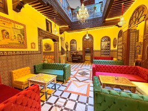 A traditional interior with ornate decor, a checkered floor, and multiple seating areas. - Riad las Mil y una Noches Tetuán (Tetouan)
