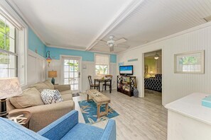 Relax in this spacious living area with a sofa, armchair, and dining table.