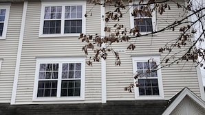 A two-story house with a garage, a visible address number, and a tree with bare branches. - Magnificent & Spacious Condo for All of Your PSU Vacations 4.5 Miles from Campus (State College)