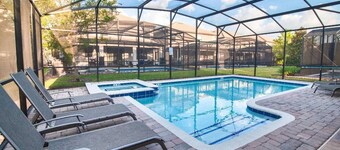 Walk to Oasis Club from this 9B/5B Champions Gate villa! Private pool, spa, sleeps up to 30.