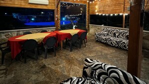 An outdoor dining area with string lights, a covered seating area, and a view of the night sky. - Villa Aresini - Events & Exclusive Residence (Montemiletto)