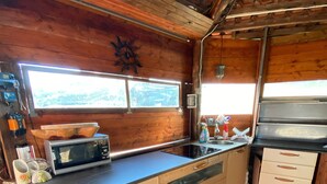 A kitchen with a large island, a microwave, a sink, and a stove. - Villa Aresini - Events & Exclusive Residence (Montemiletto)