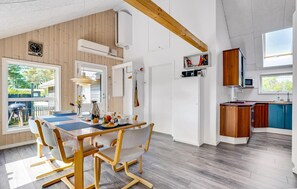 Enjoy meals with family and friends at the spacious dining table in this open-plan living area.