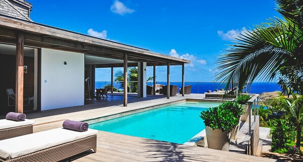 A heated pool, sun loungers