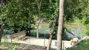 A riverside campsite with picnic tables and a canoe on the water. - "The Penthouse" #2 right on the Guadalupe, sleeps up to 15 people-private access (New Braunfels)