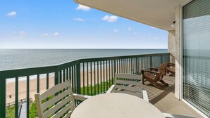 A balcony with a view of the ocean, a table, and two chairs. - Hot Tub, Pools, Wifi, Oceanfront, 7th Floor, AshWorth | AshWorth - 706 (North Myrtle Beach)