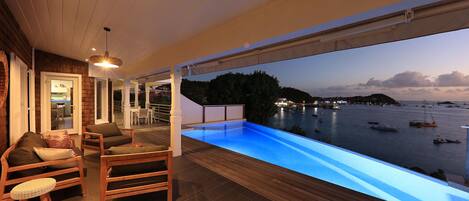 An infinity pool, pool loungers