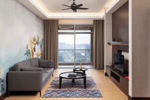 A modern living room with a sofa, coffee table, and TV stand, featuring a large window with a city view.
