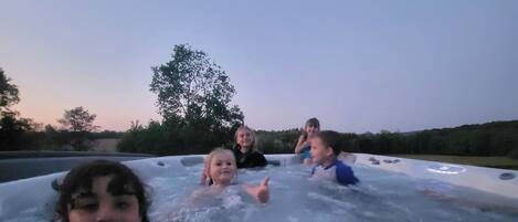 A group of people in a hot tub outdoors.