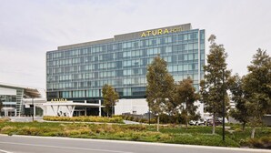 A modern hotel building with a glass facade and the name "ATURA HOTEL" on the top. - Atura Adelaide Airport (Adelaide Airport)