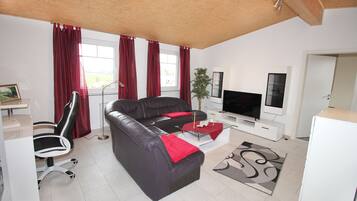 Exclusive Condo, 2 Bedrooms, Garden View | Living area | Flat-screen TV