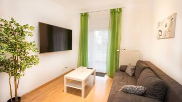 Comfort Condo, 1 Bedroom | Living room | Flat-screen TV