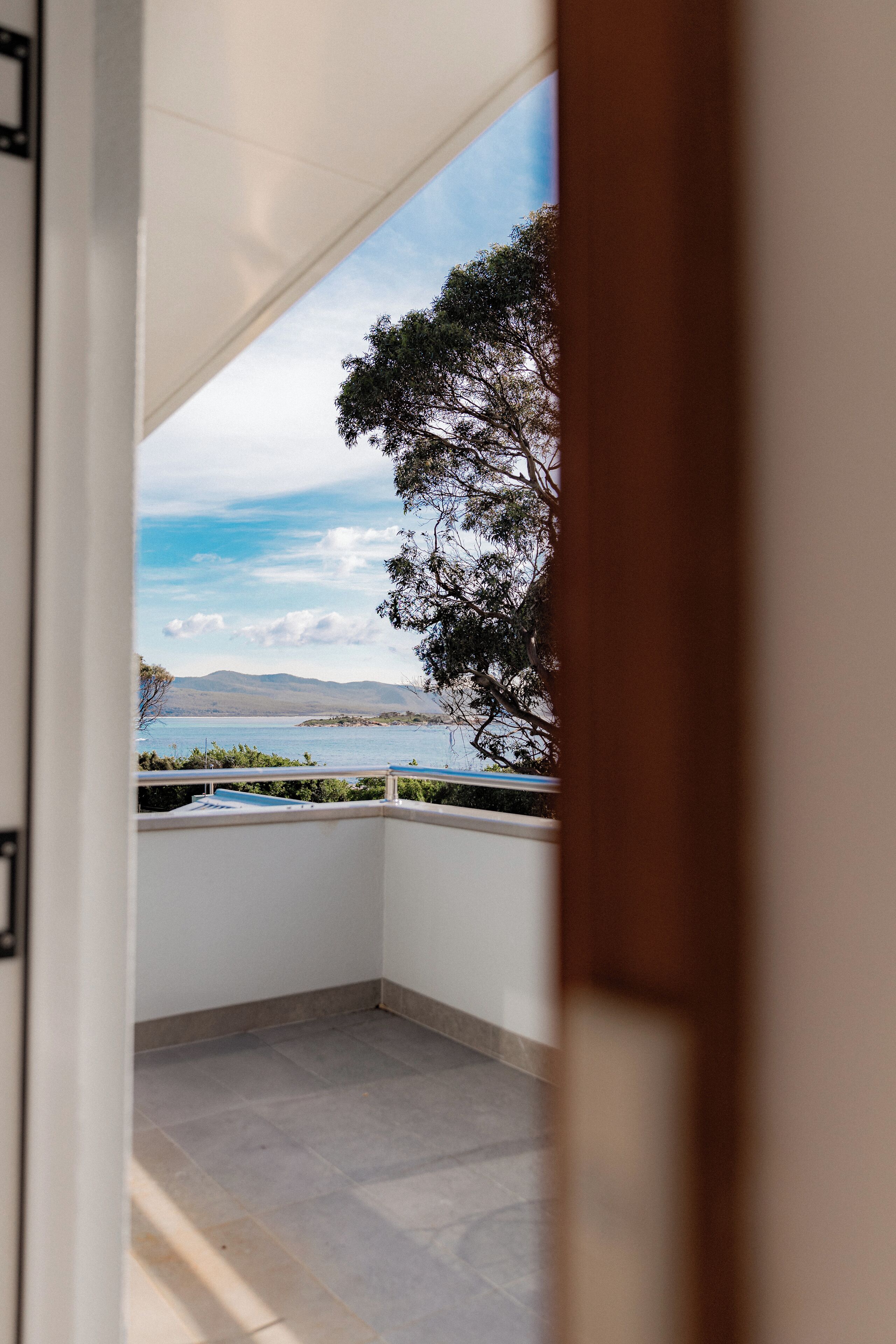 A balcony with a view of a lake and mountains.