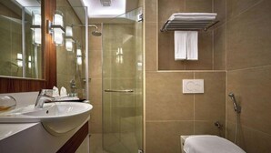 A modern bathroom with a glass-enclosed shower, a white sink, and a toilet. - Cititel Express Penang (George Town)