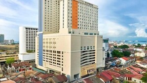 A multi-story hotel with a prominent 'City Hotel Express' sign, surrounded by a dense urban area with various buildings. - Cititel Express Penang (George Town)