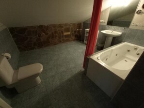 A bathroom with a toilet, sink, and bathtub.