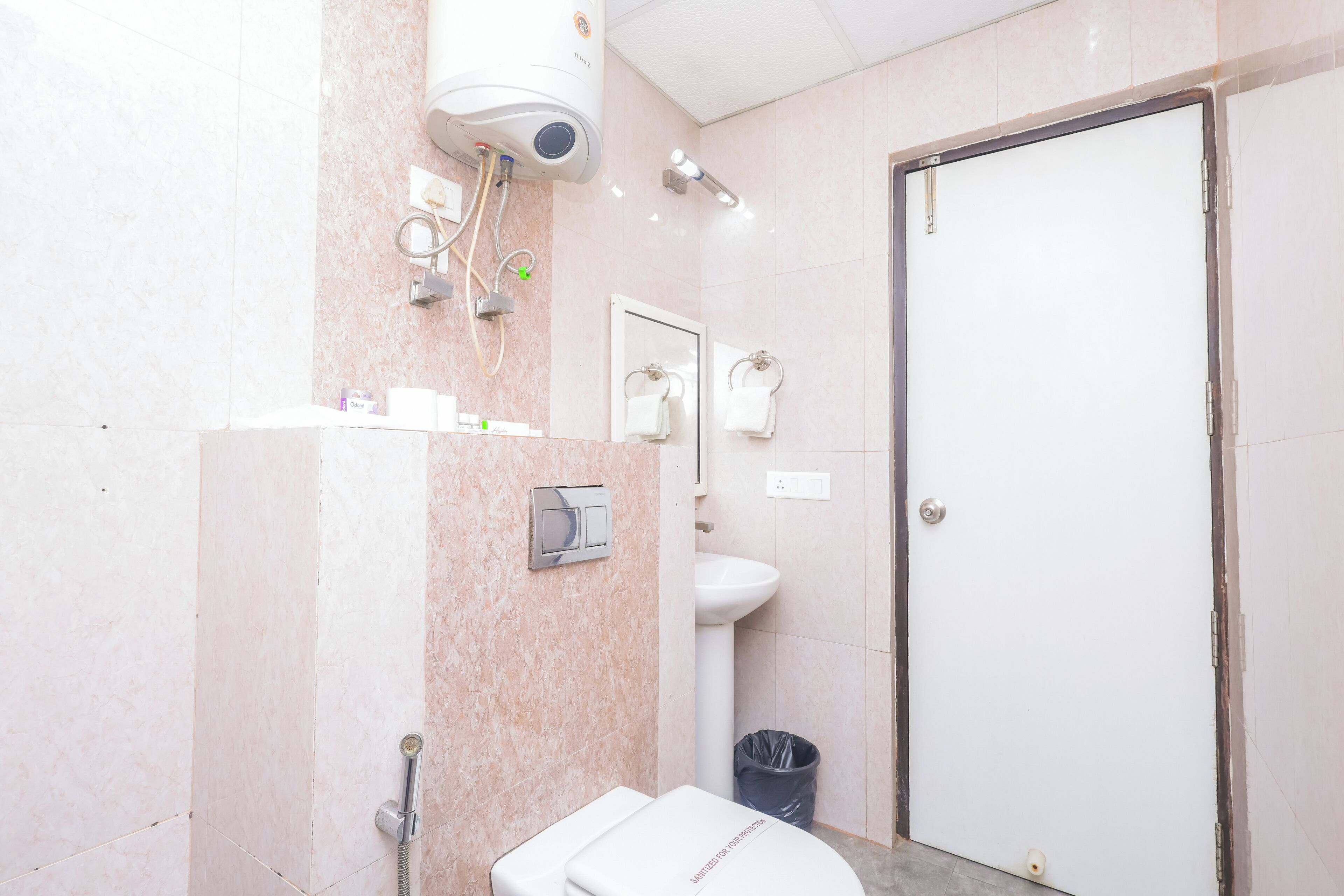 A bathroom with a toilet, sink, and shower.