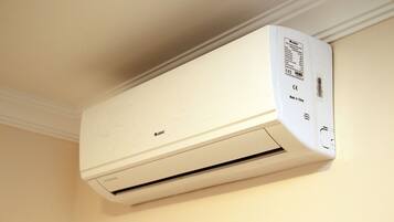 A white wall-mounted air conditioner with a brand label and a CE mark indicating it is made in China.