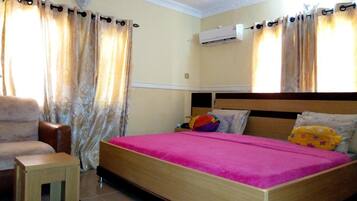 Desk, laptop workspace, blackout drapes, bed sheets