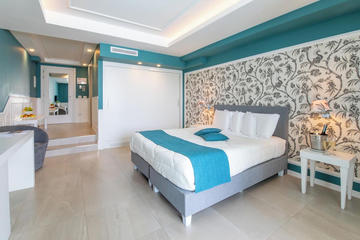 A modern bedroom with a bed, a desk, and a chair.