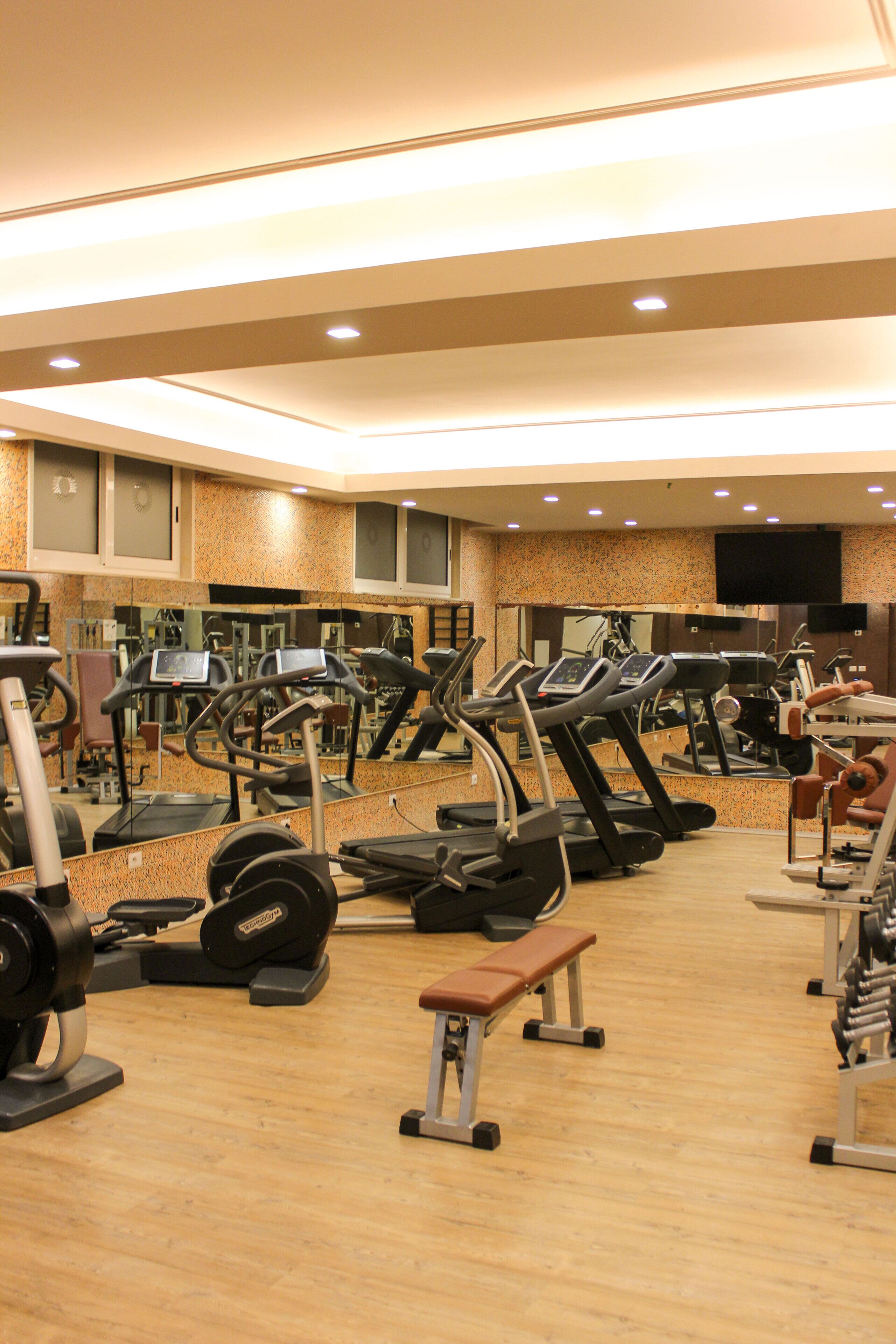 A gym with treadmills, ellipticals, and weight machines.