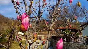 A wooden fence with a stone wall in the background. - Karyon Apartments (Xanthi)