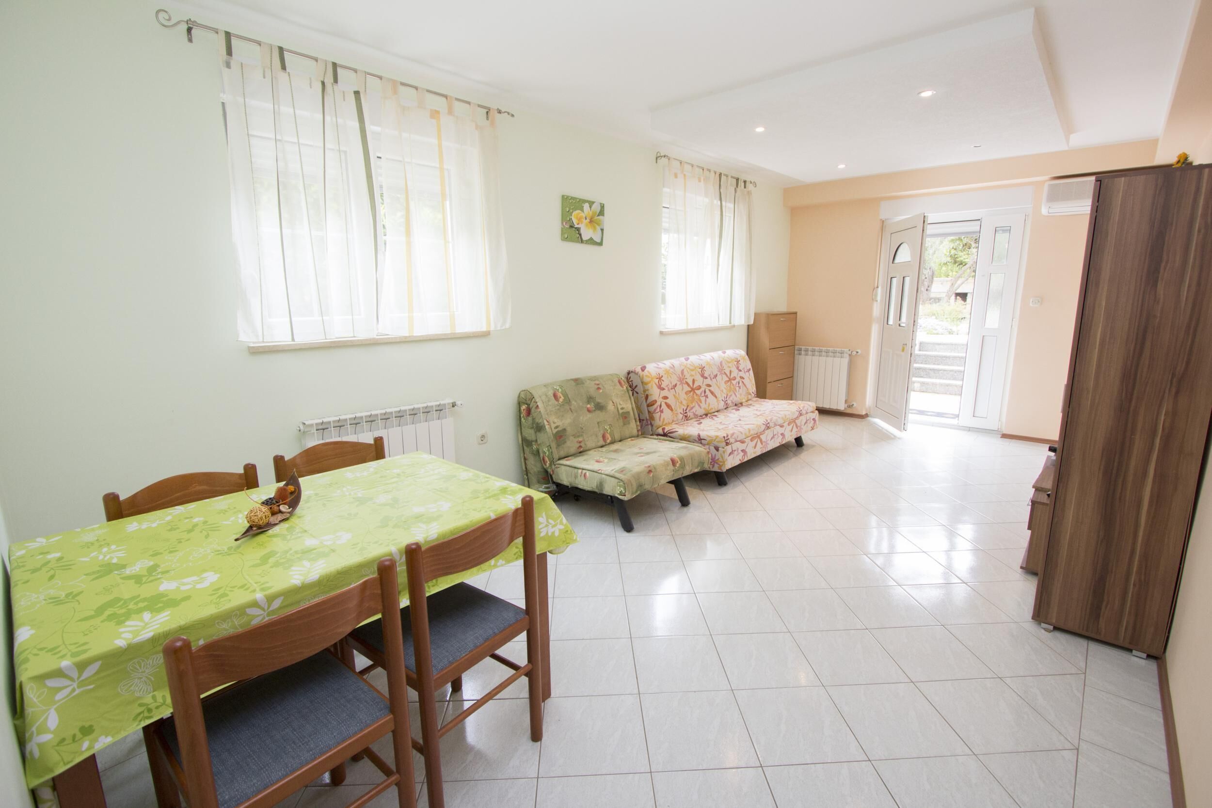 Un coin repas avec une table et des chaises, un canapé et un radiateur.