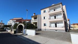 A multi-story residential building with a central courtyard, balconies, and a street view. - ELIDA Studio Apartment (Rovinj)