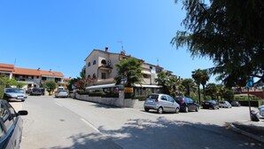 A street view with a building that has a sign indicating a restaurant.