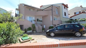 A multi-story residential building with a car parked in front. - ENI One-Bedroom Apartment 1 (mali) (Rovinj)