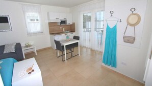 A compact living space with a kitchenette, a dining area, and a seating area. - EMANUEL Studio with Balcony 3 (Rovinj)