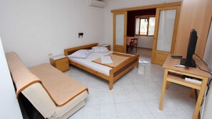 A bedroom with a bed, a bedside table, a desk with a computer, and a chair. - MARIZA Studio with Balcony (Rovinj)