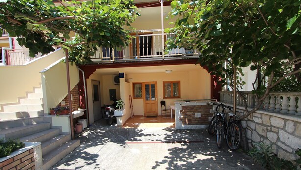 A courtyard with a staircase leading to a balcony, a bicycle parked by the wall, and a door leading to the interior. - MARIZA Studio with Balcony (Rovinj)