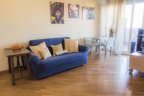 Relax in this stylish living room with a sofa, coffee table, and dining area.