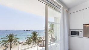 A modern kitchen with a large window overlooking a beach. - One Ibiza Suites (Ibiza Town)