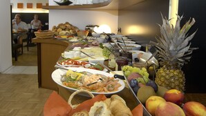 A buffet with various food items and a pineapple.