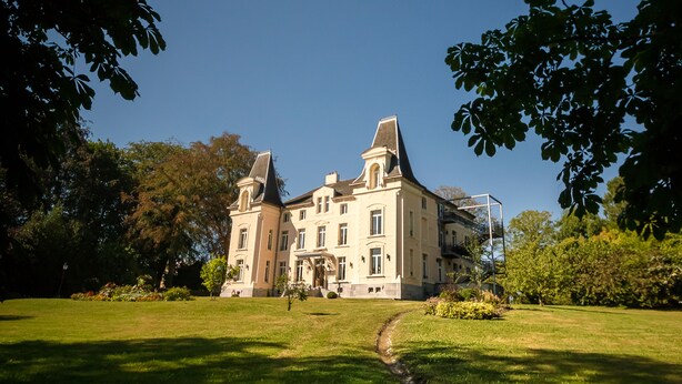 A large, historic building with a symmetrical facade, multiple chimneys, and a central entrance. - Hôtel Château de la Marlière (Fourmies)