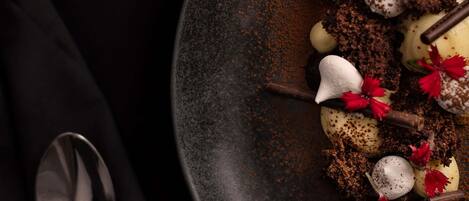 A dessert plate with various sweets and garnishes.