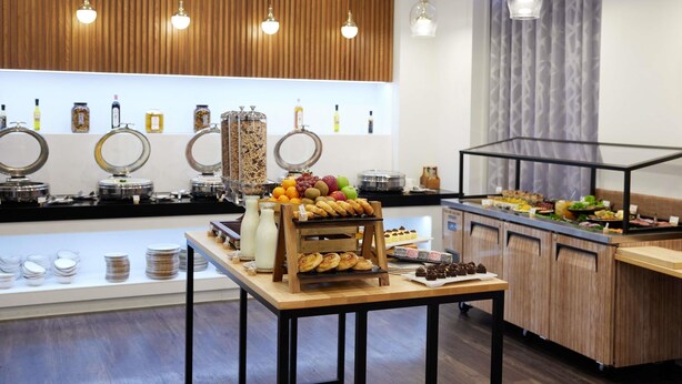 A buffet setup with various food items and condiments.