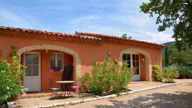 A two-story building with a tiled roof, arched doorways, and a gravel driveway. - Les Jardins de l'Ermitage (Les Salles-sur-Verdon)